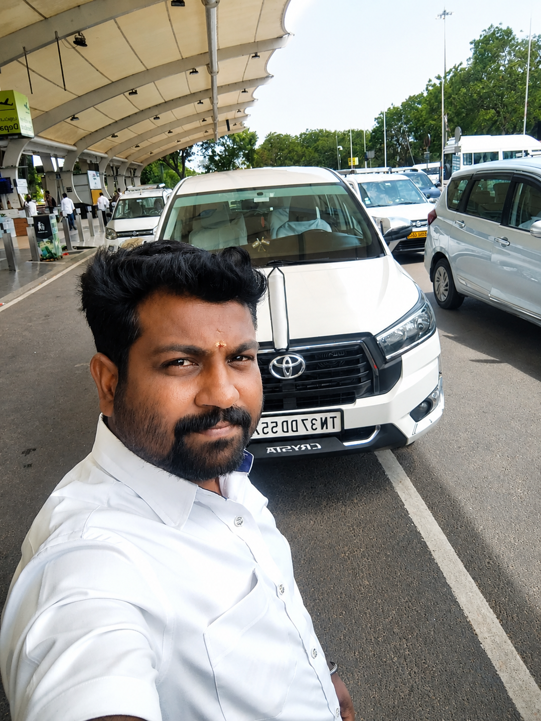 Pandiyan, founder of Travel Nest, beside a Travel Nest vehicle